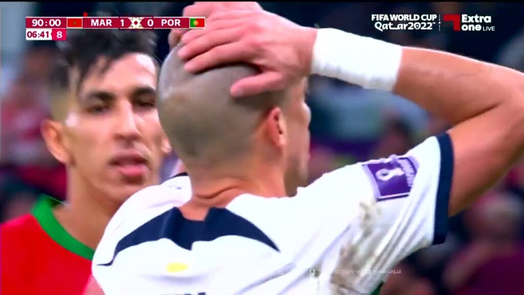Morocco player Jawad El Yamiq kisses Pepe's head
