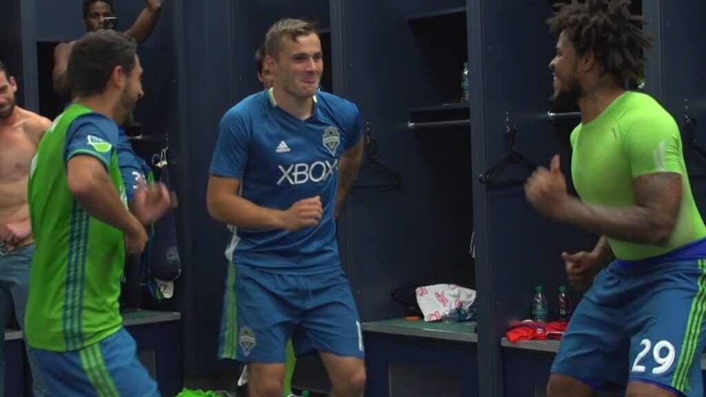 Román Torres, Cristian Roldan and Jordan Morris dance in locker room following win