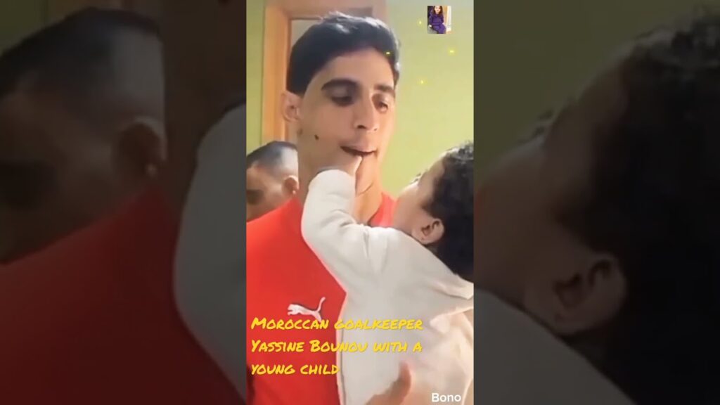 Moroccan goalkeeper Yassine Bounou with a young child