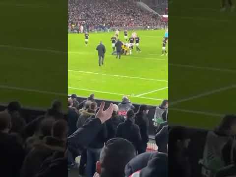 Sevilla goalkeeper Marko Dmitrovic calmly incapacitates a PSV hooligan who tries to punch him