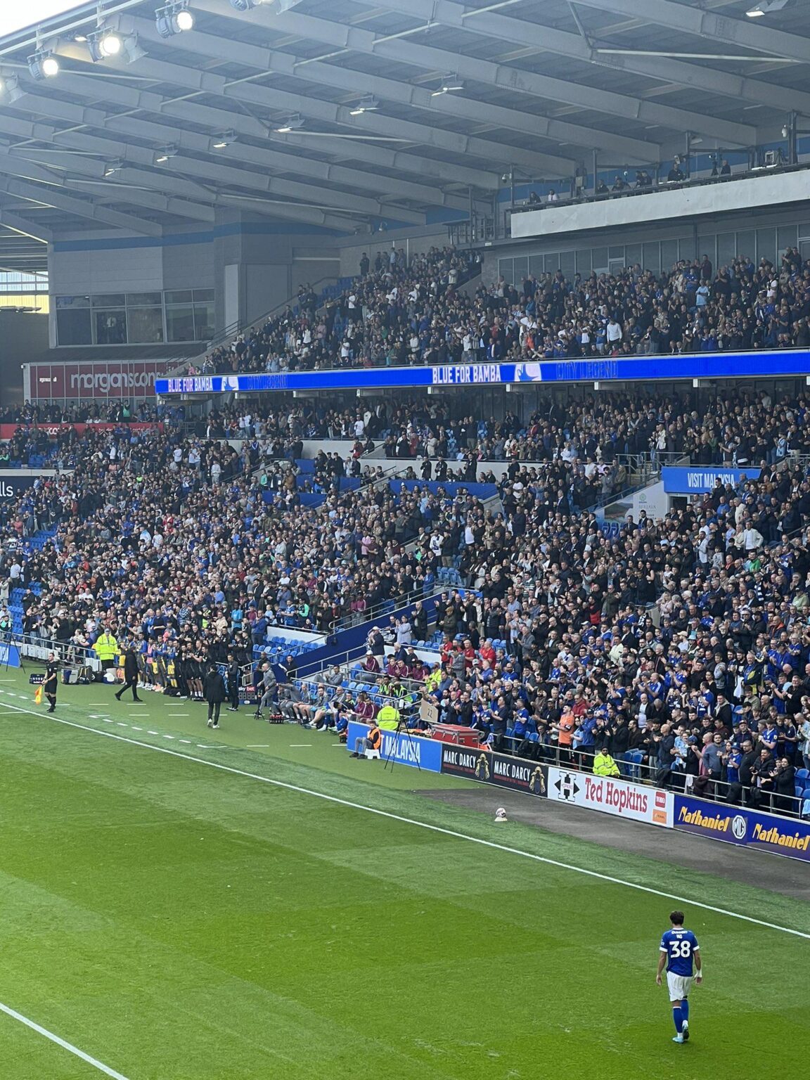 Cardiff Staff and Bench showing their class by being the only people in the stadium not on their feet for Sol Bamba at the 14th minute.