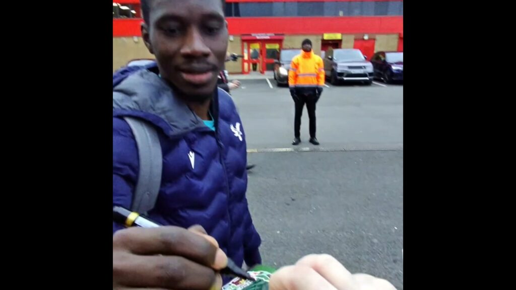 Ismaïla Sarr smiles when fan asks him to sign a Senegal National Team Card.