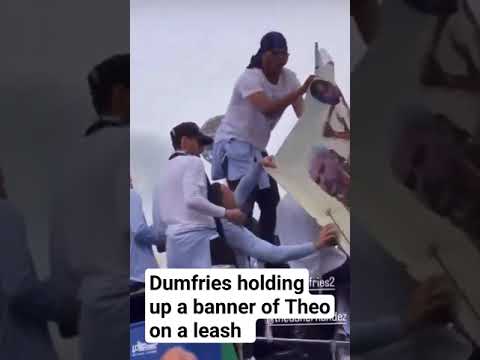 Denzel Dumfries holding up a banner of Theo Hernandez on a leash