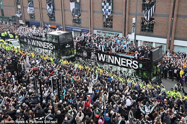 Two buses, decked out in Newcastle's signature black and white, bear the slogan 'WINNERS 24/25'