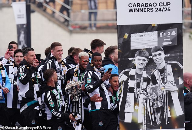 Newcastle United players take in the atmosphere as the victory parade sets off at St James' Park