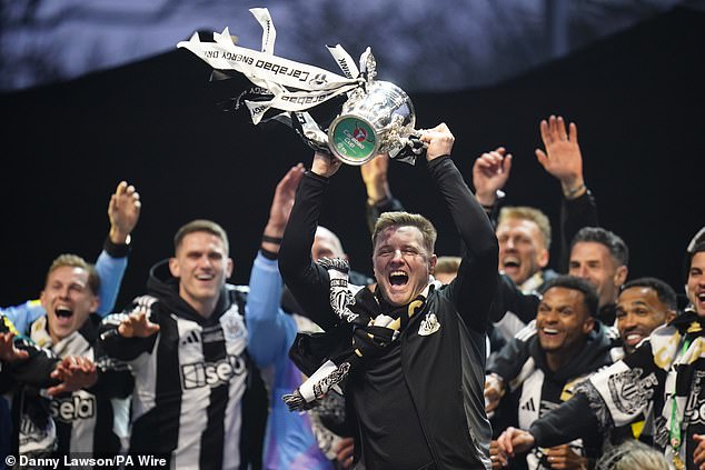 Newcastle manager Eddie Howe hoists the Carabao Cup aloft at the victory parade on Saturday evening