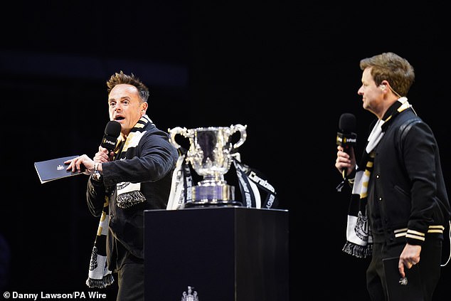 Newcastle superfans Ant and Dec prepare to hand over the trophy to the players on stage
