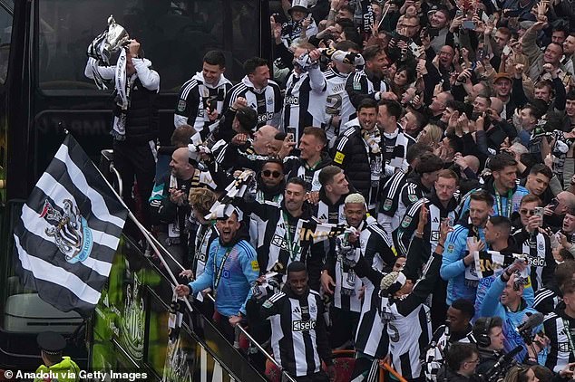 Newcastle United players celebrate the Carabao Cup with their fans during an open bus parade in Newcastle