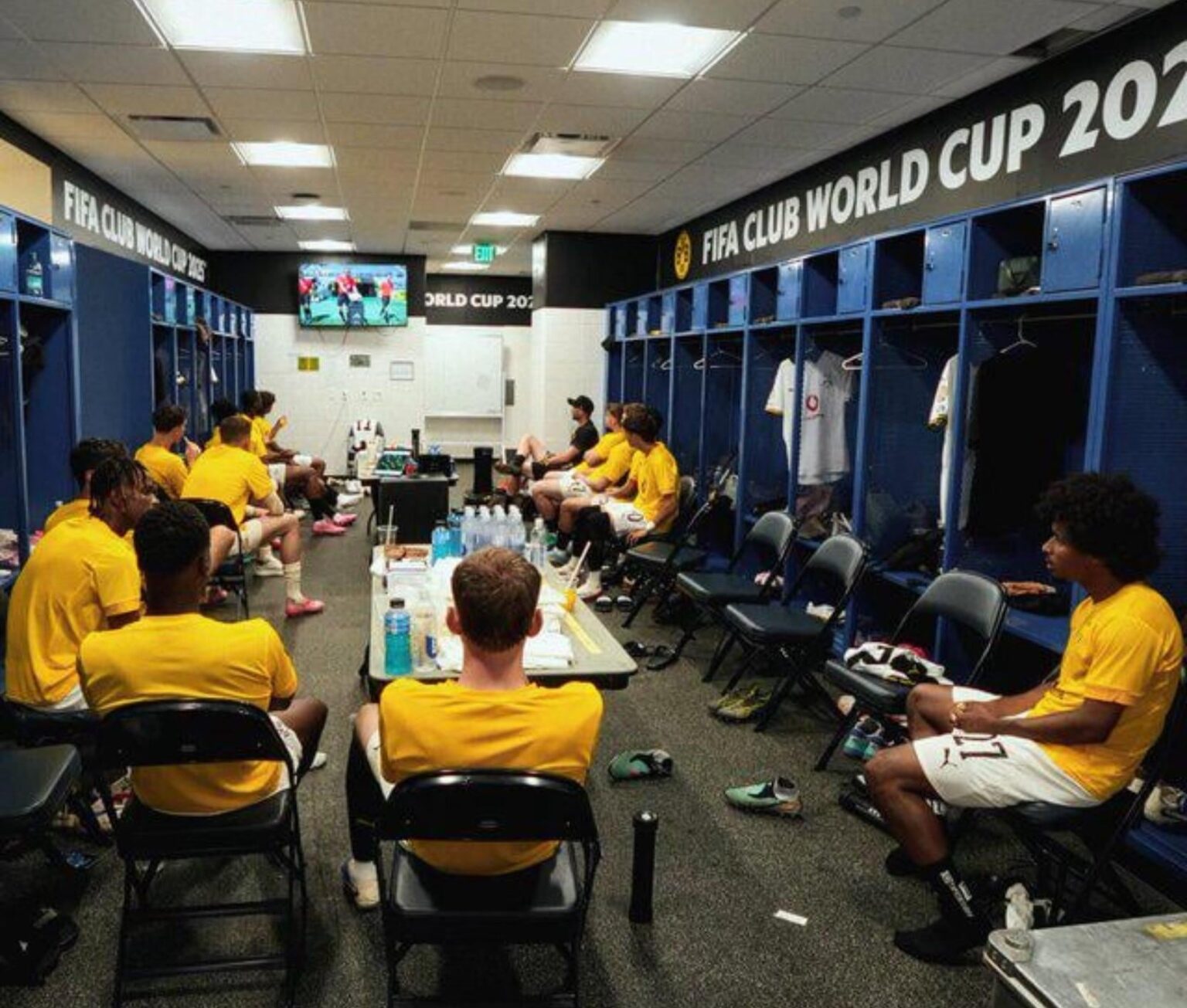 Bench players watching the game from inside locker room due to heat.