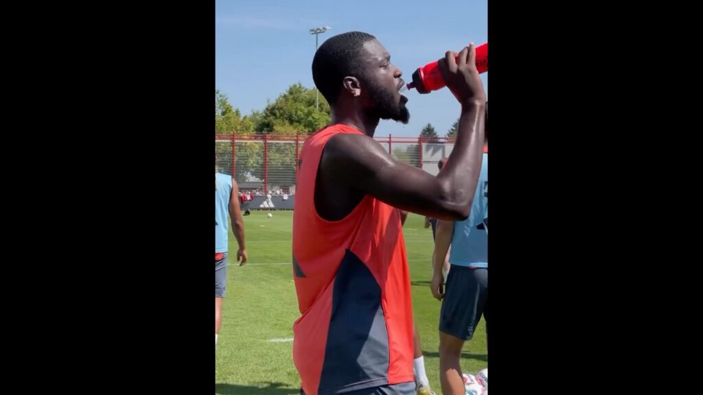 Dayot Upamecano drinking water during a break on Bayern's training session