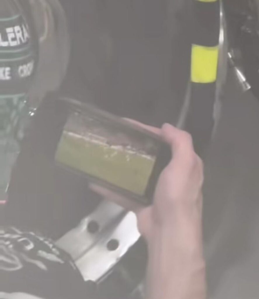Mercedes F1 pit crew member spotted watching the game during qualifying.