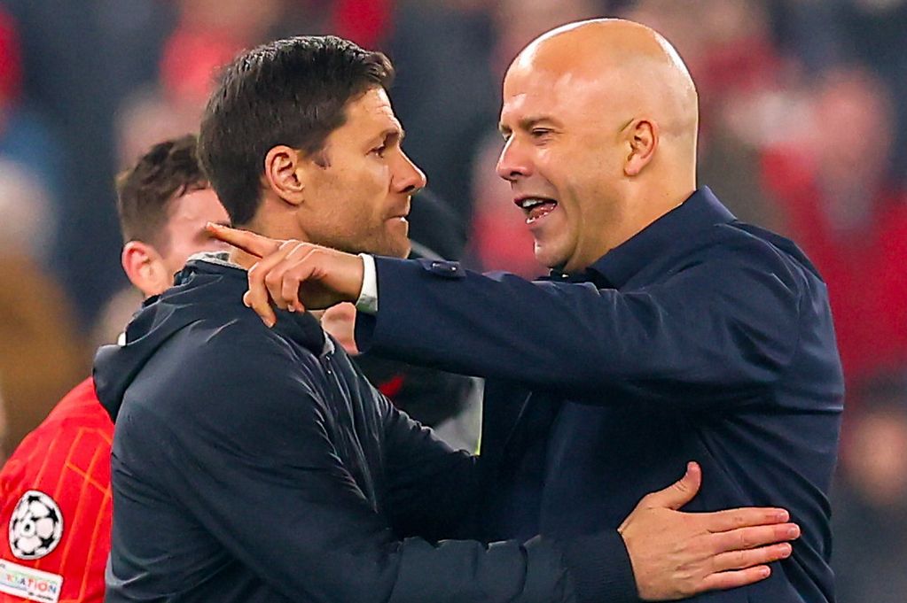 Xabi Alonso and Arne Slot embrace following Liverpool's win over Bayer Leverkusen