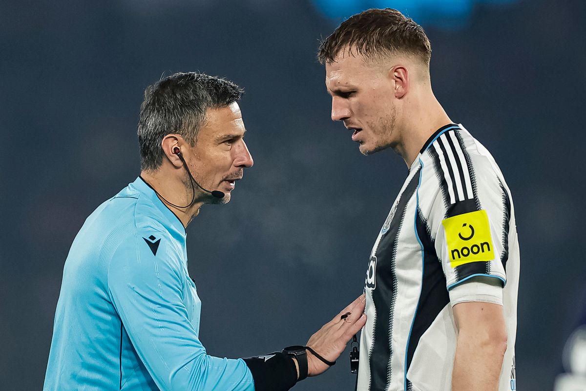 Newcastle United's Dan Burn speaks to referee Slavko Vincic