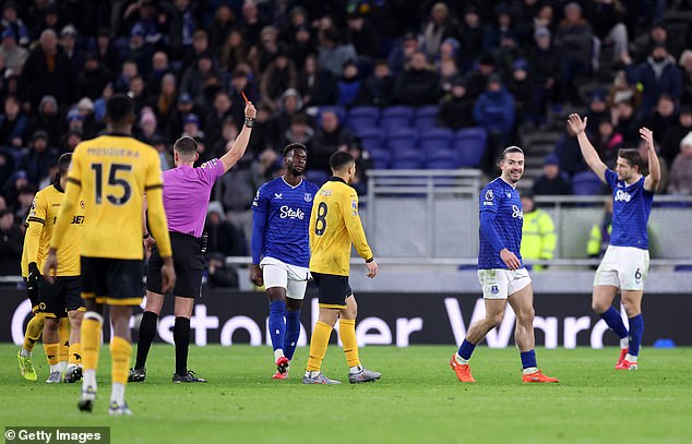 Jack Grealish smiles as he is shown a second yellow card for dissent, reducing Everton to nine