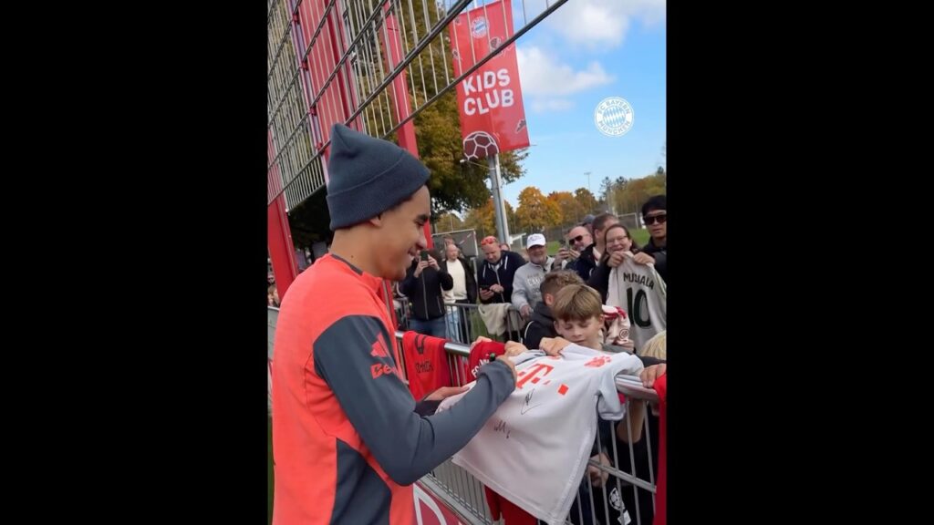 Jamal Musiala signing some shirts and taking some time for kids fans at Bayern's training session