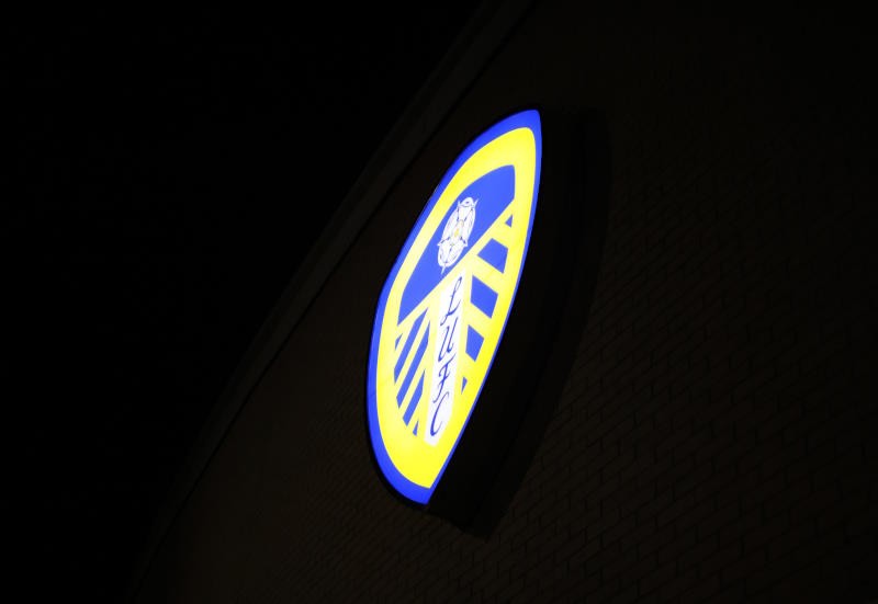 Leeds United's badge lit up at night at Elland Road