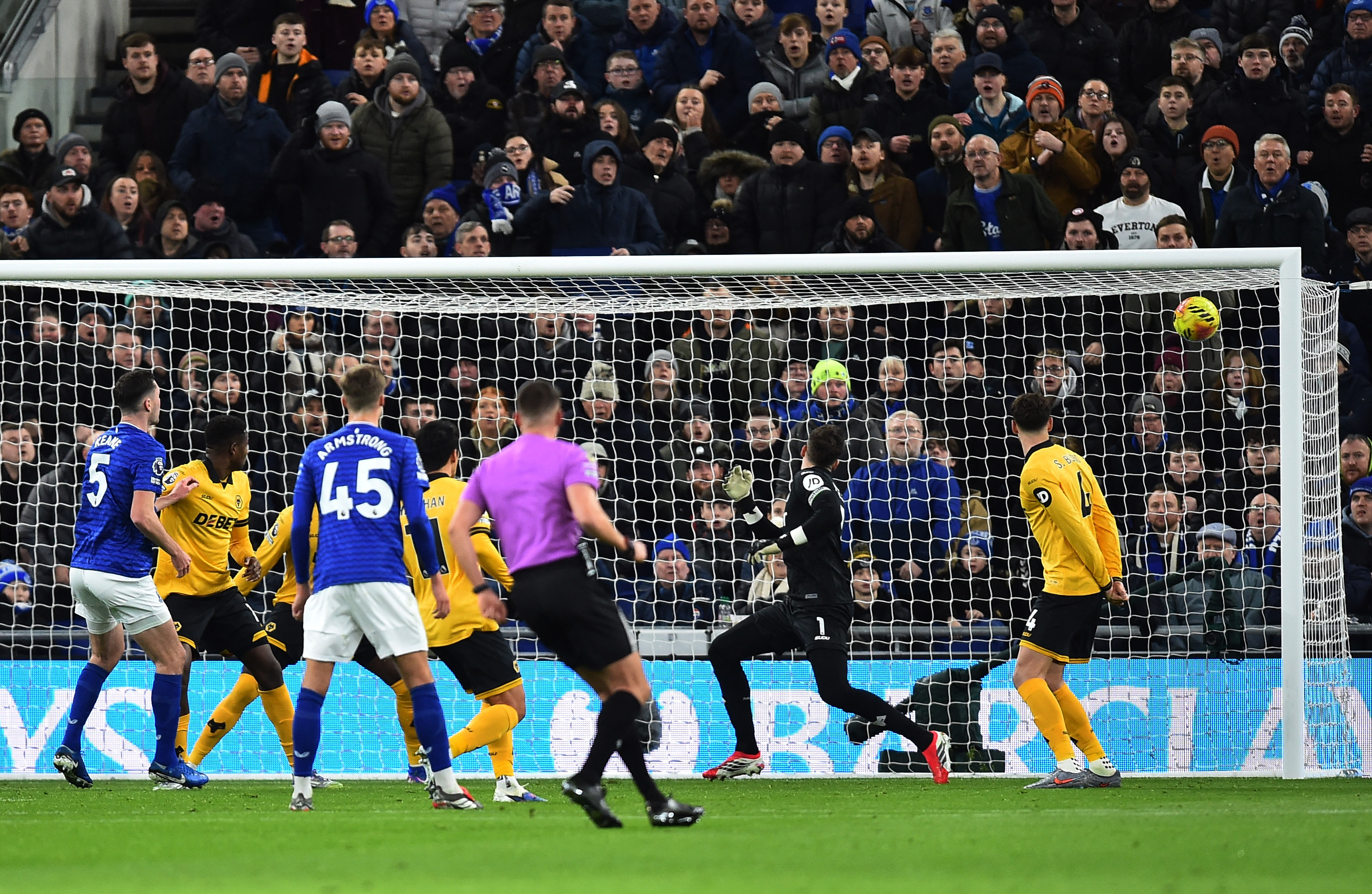 Everton's Michael Keane scoring their first goal against Wolverhampton Wanderers' Jose Sa.