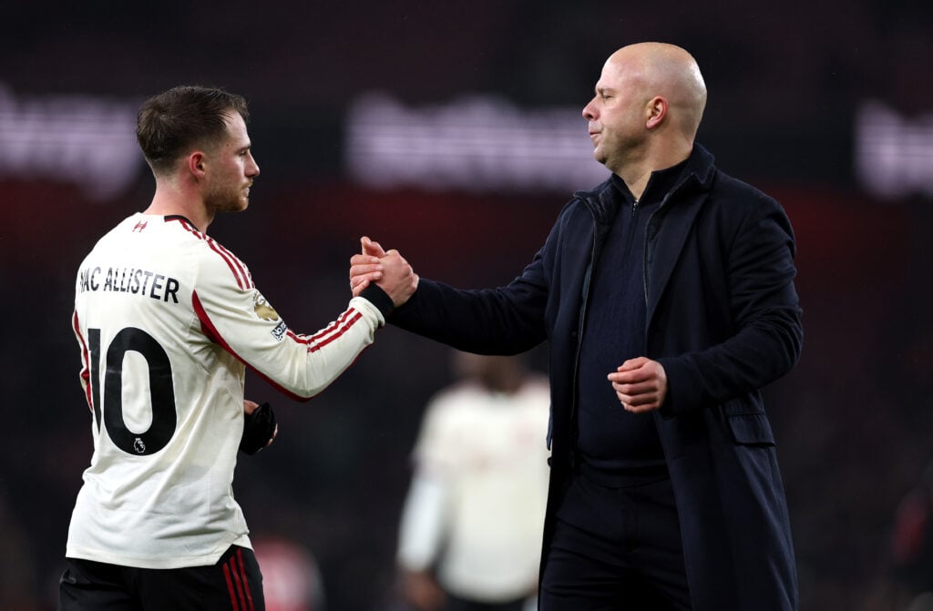 Alexis Mac Allister and Arne Slot clasp hands after Liverpool's Premier League match against Arsenal at the Emirates Stadium.