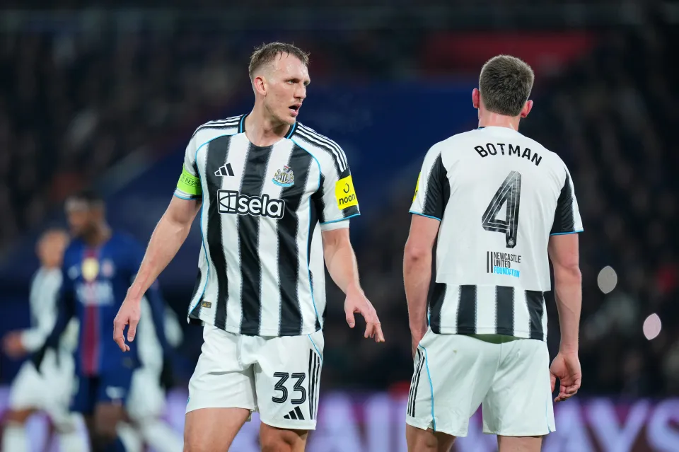 Dan Burn of Newcastle United speaks with teammate Sven Botman during the UEFA Champions League 2025/26 League Phase MD8 match between Paris Saint-Germain and Newcastle United FC at Parc des Princes on January 28, 2026 in Paris, France.
