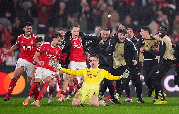 Anatoliy Trubin of Benfica celebrates scoring his team's fourth goal with a header with teammates during the UEFA Champions League 2025/26 League Phase MD8 match between SL Benfica and Real Madrid C.F. at Estadio do SL Benfica