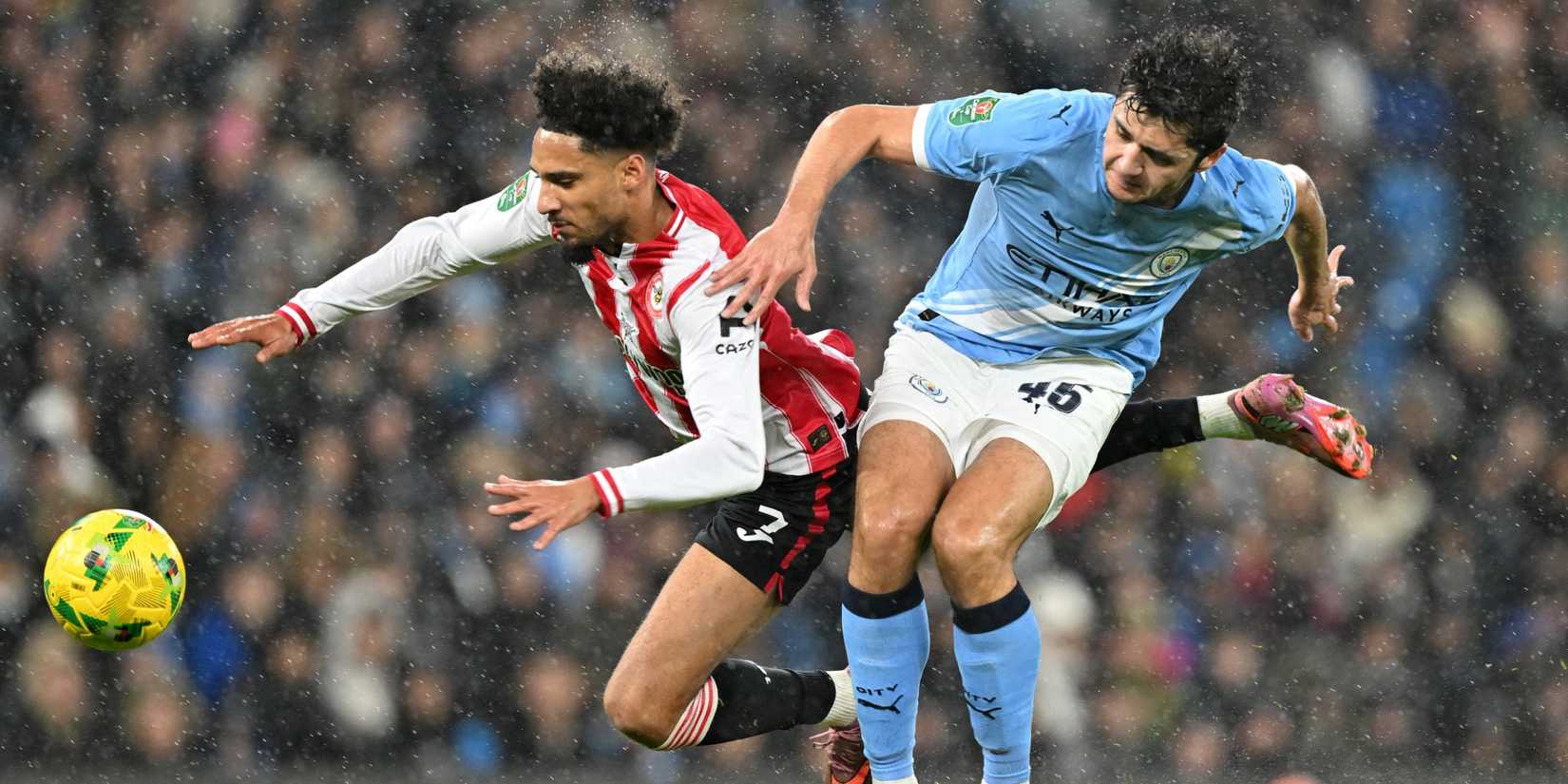 Brentford's Kevin Schade in action with Manchester City's Abdukodir Khusanov