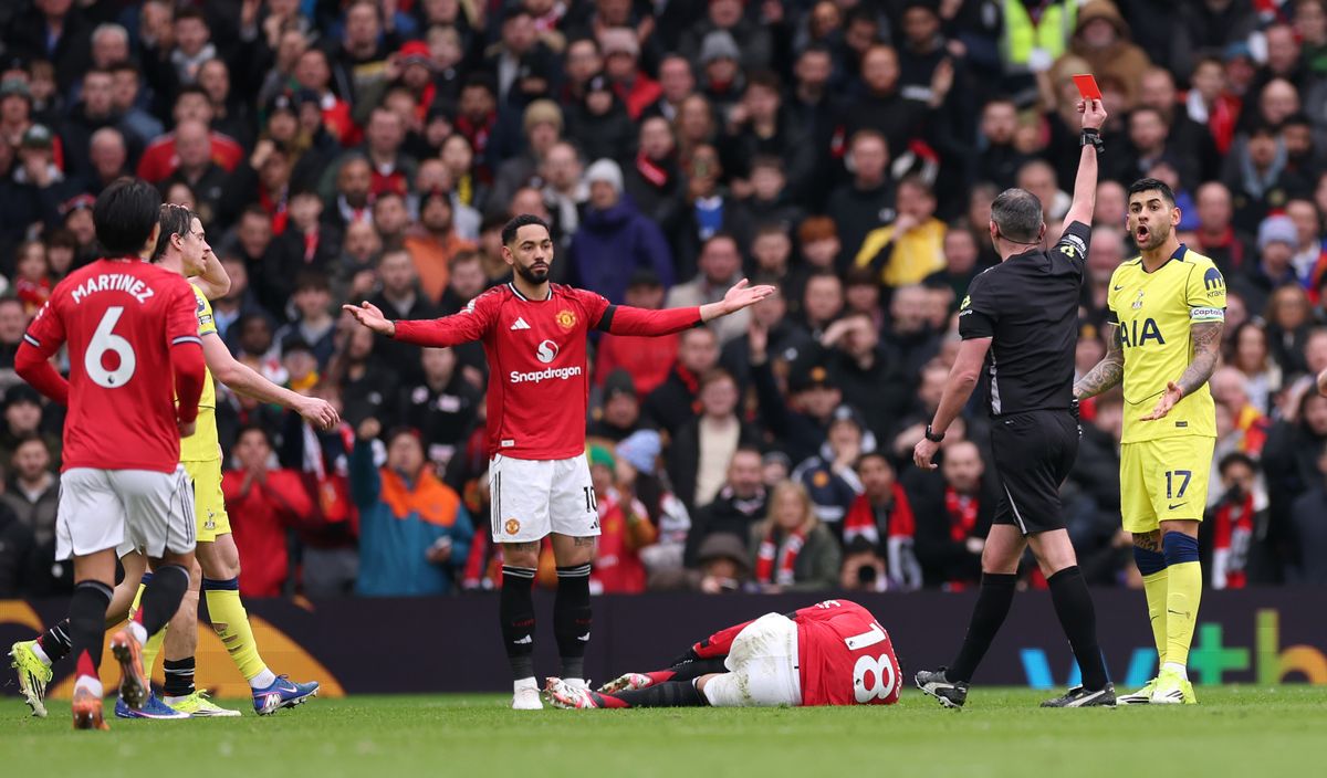 Cristian Romero of Tottenham Hotspur is shown a red card by referee Michael Oliver after a foul on Casemiro of Manchester United and will now miss clash with Arsenal
