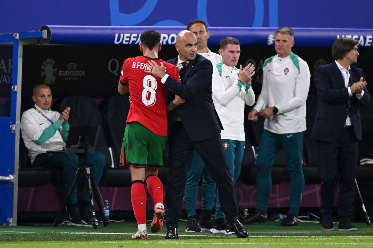 Bruno Fernandes of Portugal is embraced by Roberto Martinez, Head Coach of Portugal, after he is substituted during the UEFA EURO 2024 quarter-final match between Portugal and France at Volksparkstadion on July 05, 2024 in Hamburg, Germany
