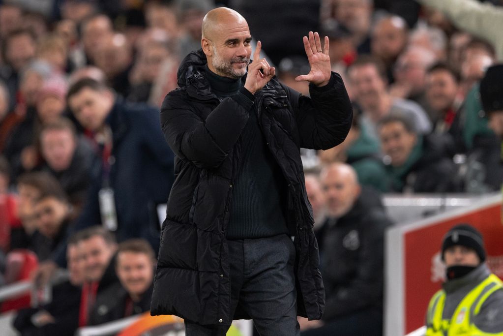 LIVERPOOL, ENGLAND - DECEMBER 1: Manchester City manager Pep Guardiola holds up six fingers to indicate the six premier league titles he has won after Liverpool fans sing 'you're getting sacked in the morning' during the Premier League match between Liverpool FC and Manchester City FC at Anfield on December 1, 2024 in Liverpool, England. (Photo by Visionhaus/Getty Images)