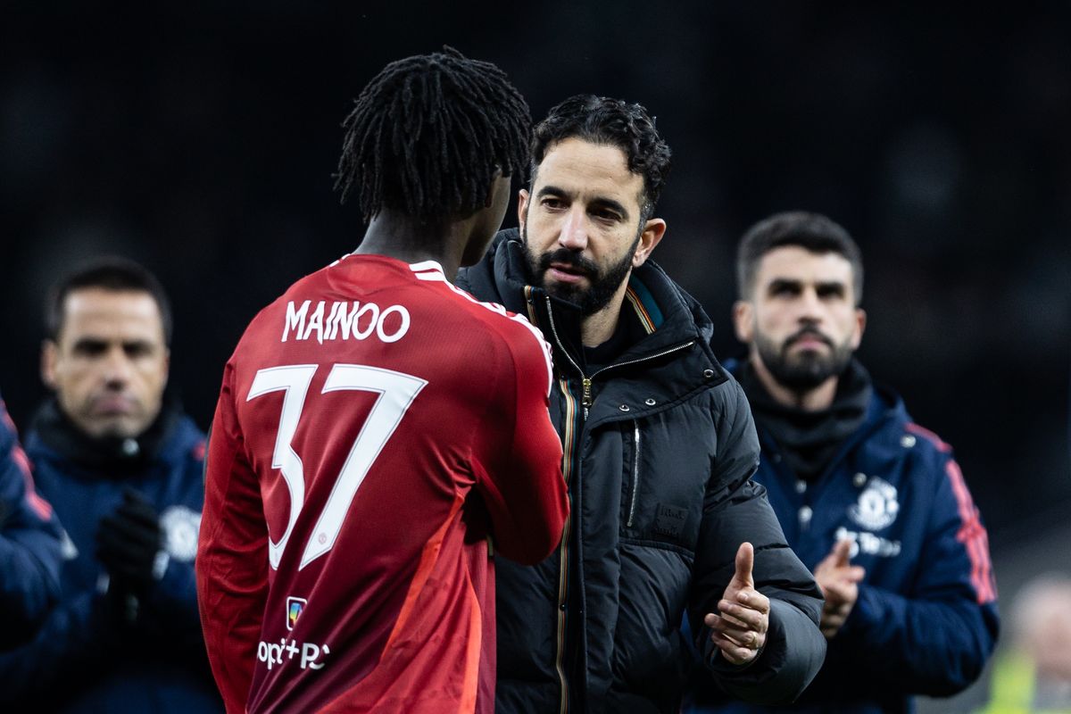 Manchester United's manager Ruben Amorim consoles Kobbie Mainoo at the end of the match during the Carabao Cup Quarter Final match between Tottenham Hotspur and Manchester United at Tottenham Hotspur Stadium on December 19, 2024 in London, England. 