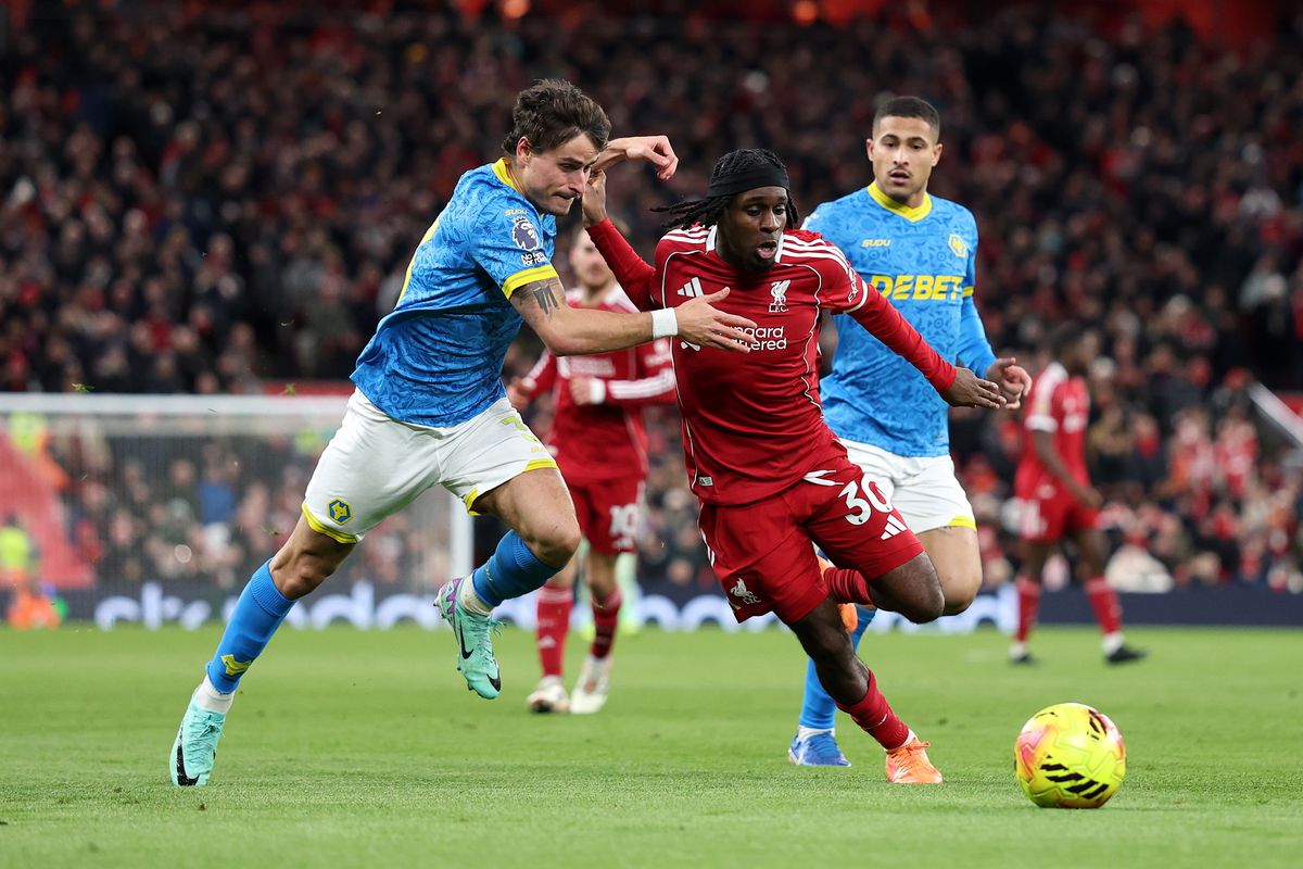 Jeremie Frimpong of Liverpool is challenged by Hugo Bueno of Wolverhampton Wanderers.