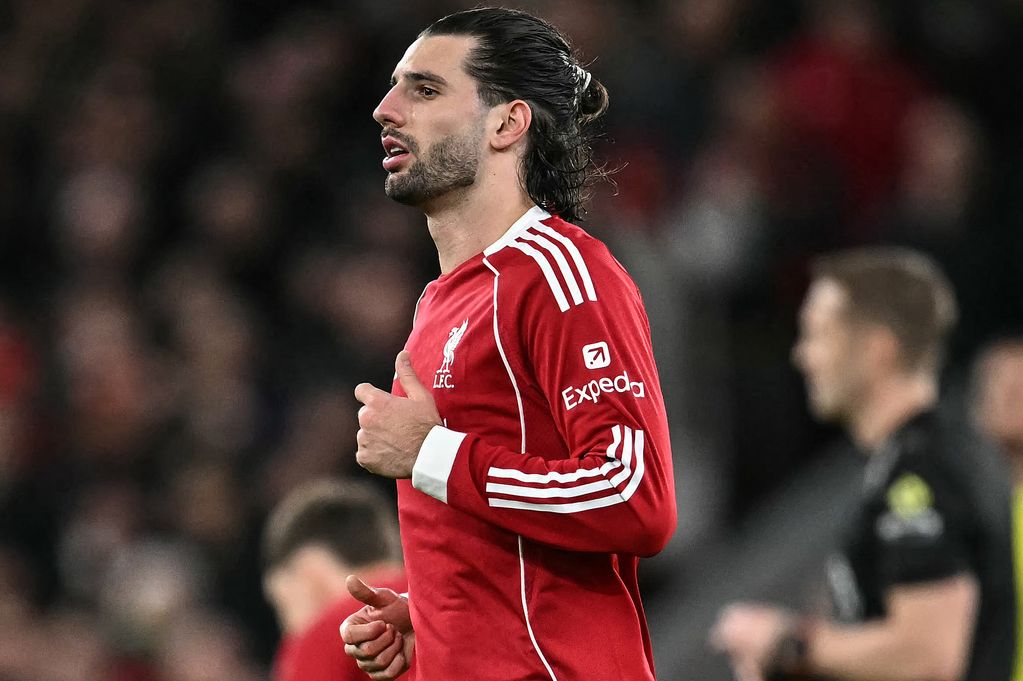 Liverpool's Hungarian midfielder #08 Dominik Szoboszlai (C) walks back after scoring his team's first goal during the English Premier League football match between Liverpool and Manchester City at Anfield in Liverpool, north west England on February 8, 2026. (Photo by Paul ELLIS / AFP via Getty Images) / RESTRICTED TO EDITORIAL USE. No use with unauthorized audio, video, data, fixture lists, club/league logos or 'live' services. Online in-match use limited to 120 images. An additional 40 images may be used in extra time. No video emulation. Social media in-match use limited to 120 images. An additional 40 images may be used in extra time. No use in betting publications, games or single club/league/player publications. /