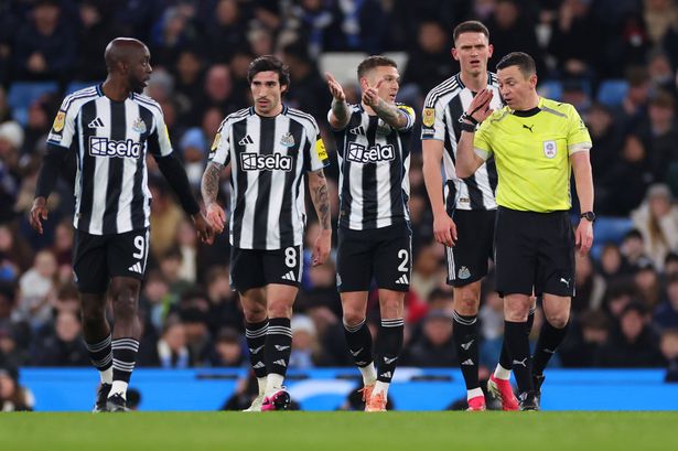 Newcastle players react on the pitch.