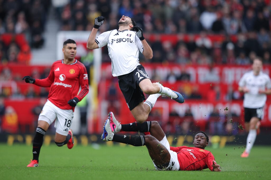 Raul Jimenez is tackled by Kobbie Mainoo of Manchester United during the Premier League match between Manchester United and Fulham at Old Trafford in 2026 in Manchester, England.