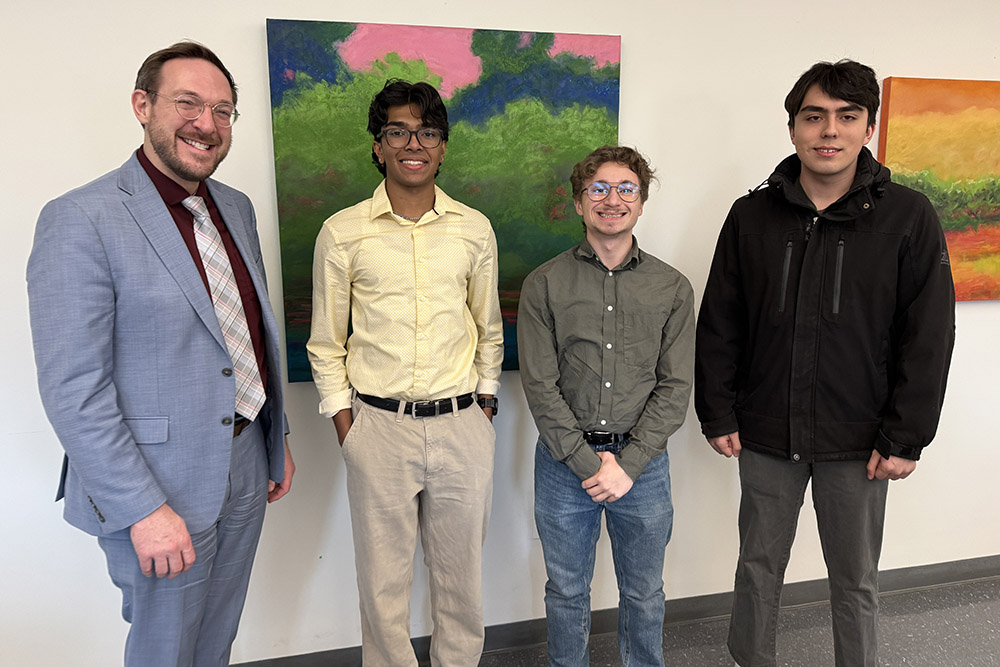 SUNY Vice Chancellor for Workforce Development and Upward Mobility Chris White with students Ajay Dhanraj (sustainability studies and MBA), Michael Pietraniello (mechanical engineering) and Paul Felske (sustainability studies).