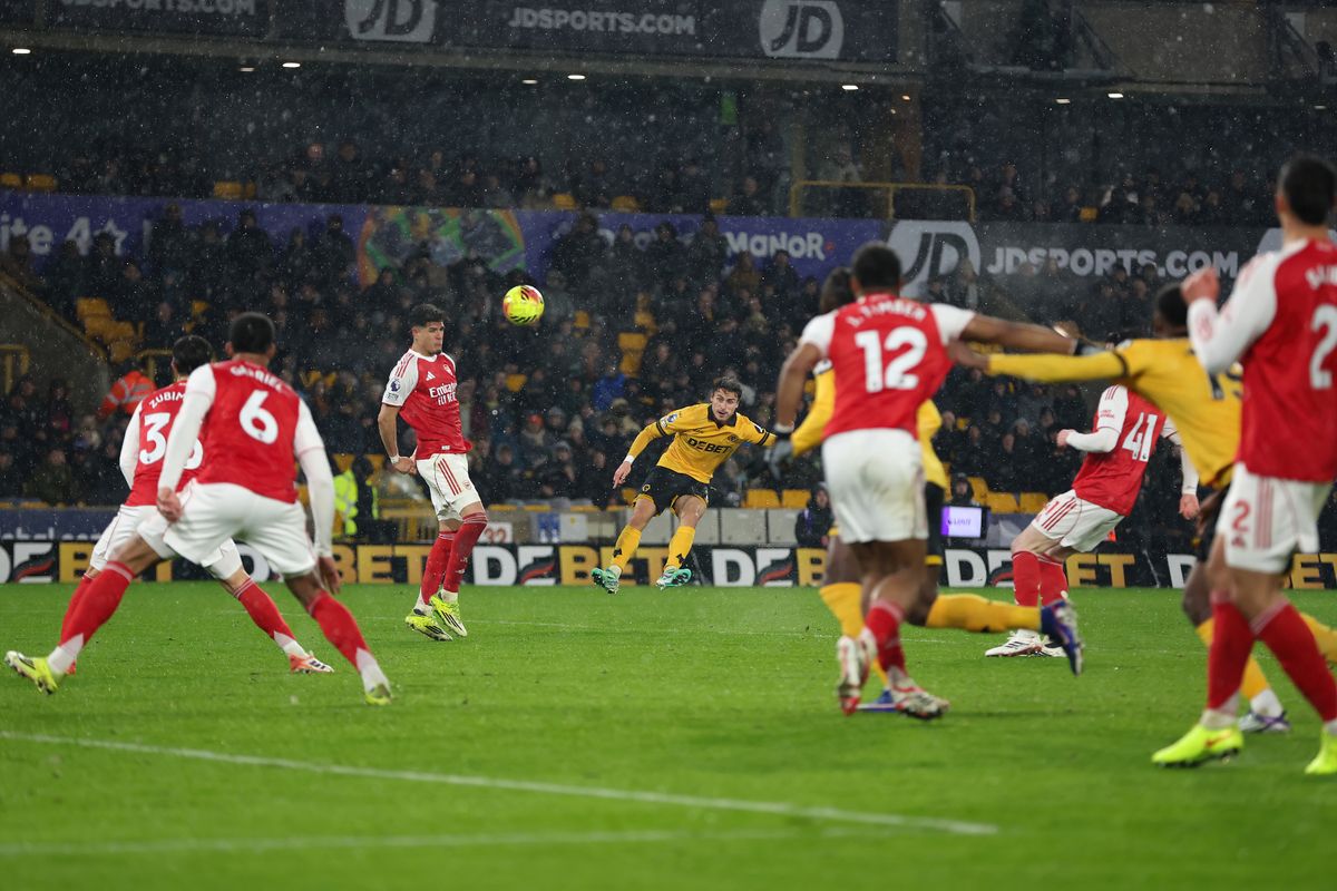 Hugo Bueno of Wolverhampton Wanderers scores against Arsenal