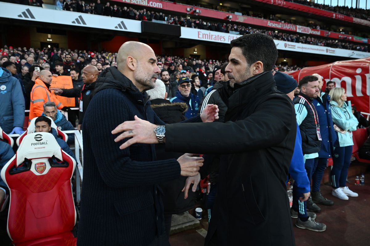 Pep Guardiola, manager of Manchester City, embraces Mikel Arteta, Manager of Arsenal, prior to the Premier League match between Arsenal FC and Manchester City FC at Emirates Stadium