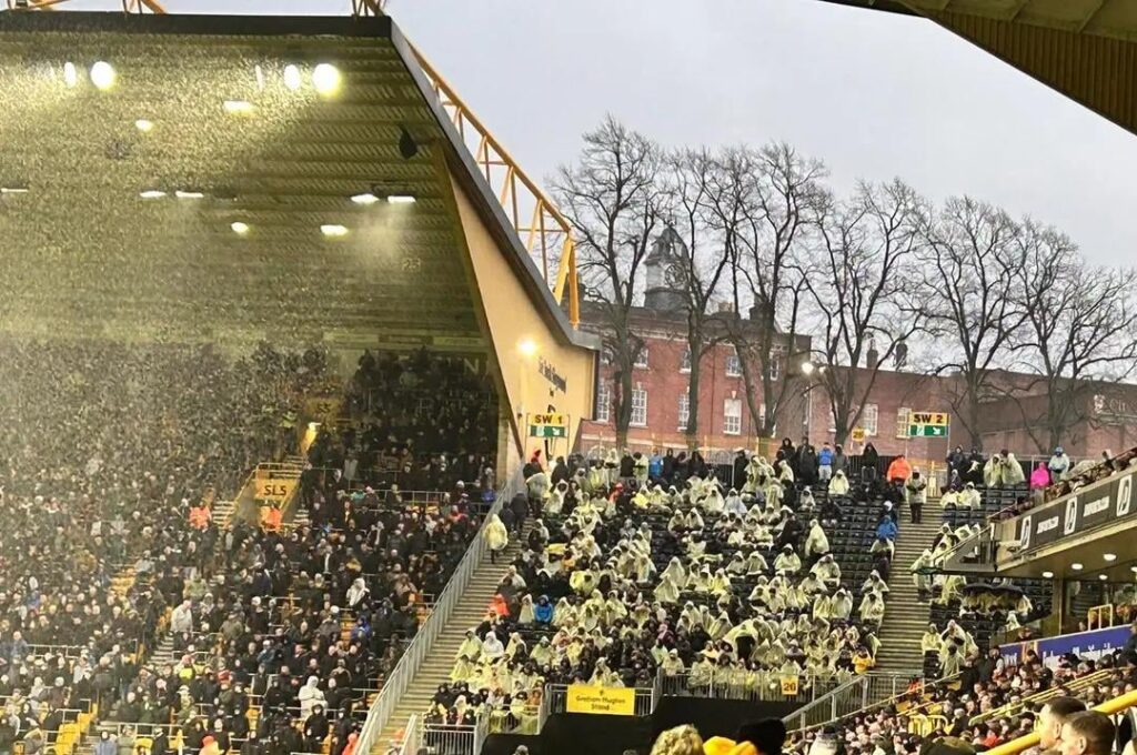 Just seen this on fb. Surely this cant be real can it? Giving people ponchos to sit there in the rain instead on putting a roof on it?