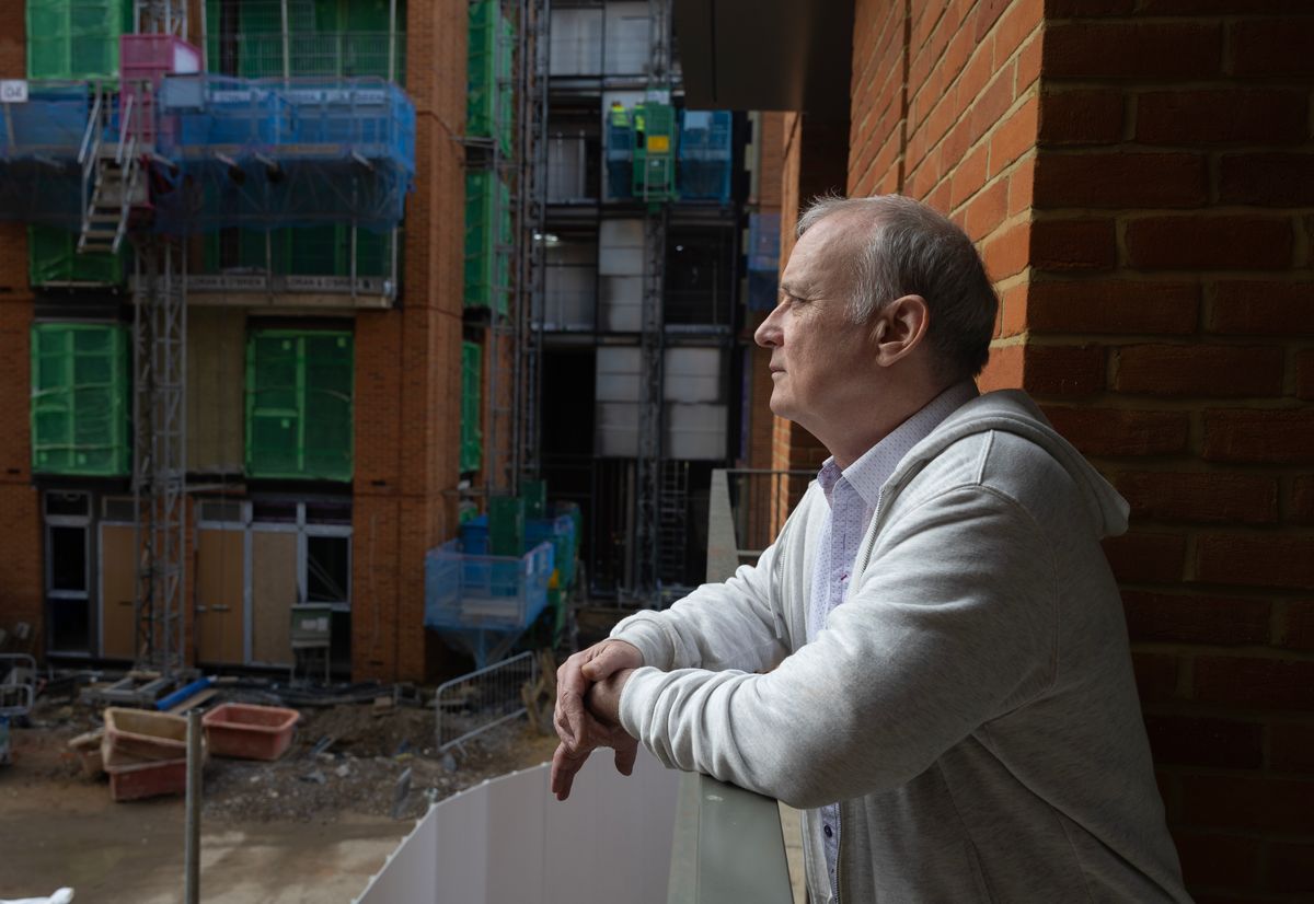 David McGinty poses for photos in his home in Fulham