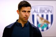 WALSALL, ENGLAND - JANUARY 14: Eric Ramsay Head Coach of West Bromwich Albion pictured next to a club crest / badge in his offic