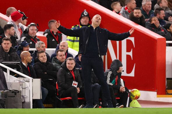 Arne Slot with his arms up, complaining on the touchline.