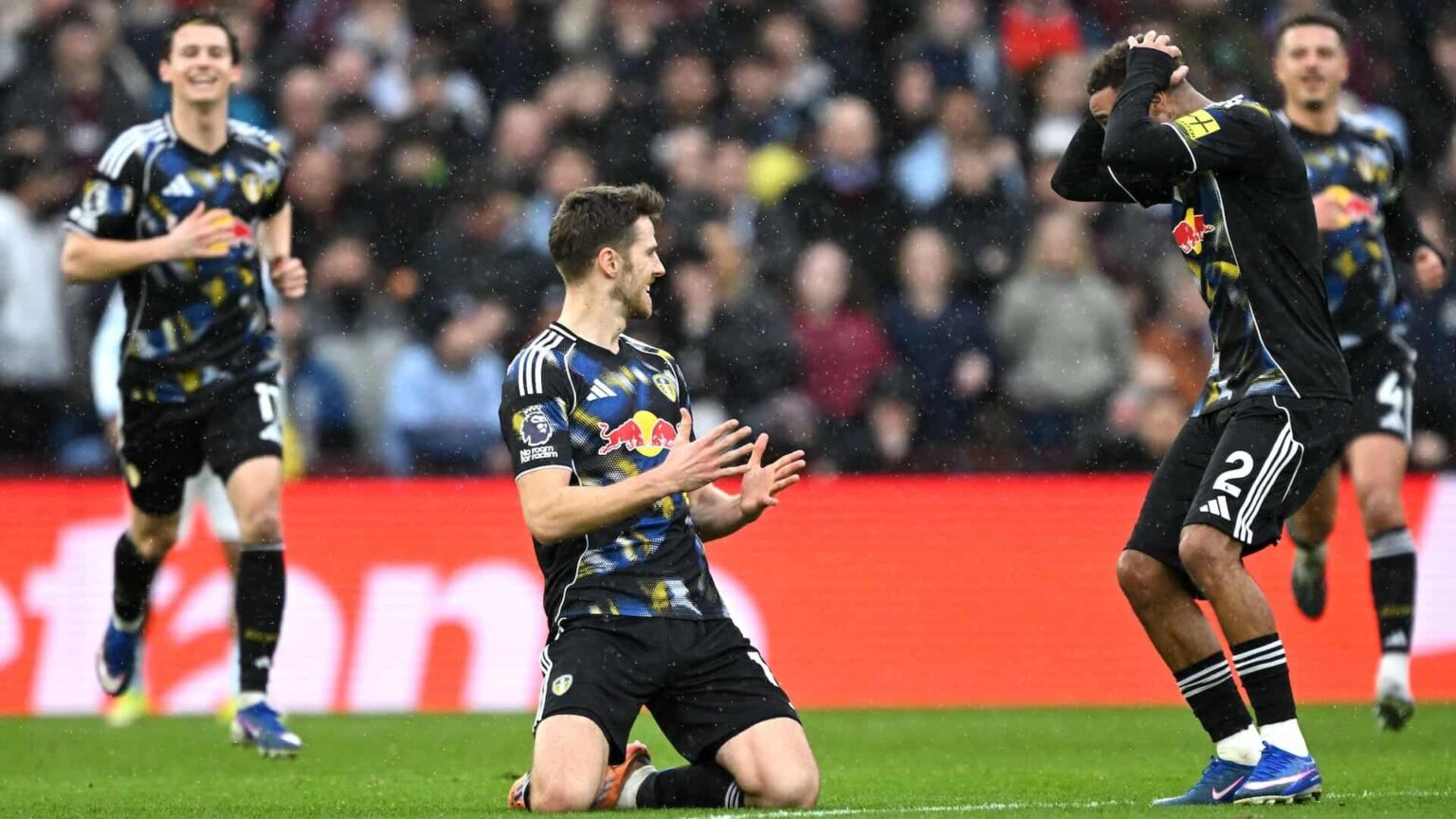 Anton Stach slides on his knees celebrating his wonder goal at Villa Park while Jayden Bogle stands with his head in his hands refusing to believe it