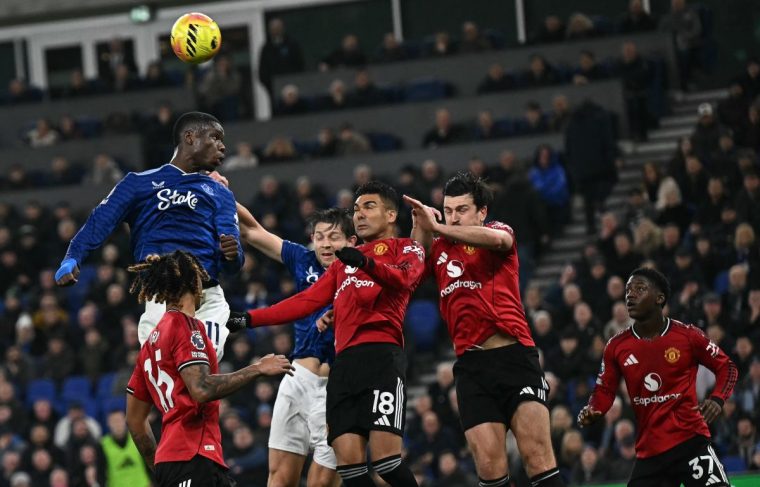 Everton's French striker #11 Thierno Barry jumps above Manchester United's Brazilian midfielder #18 Casemiro and Manchester United's English defender #05 Harry Maguire to header a corner during the English Premier League football match between Everton and Manchester United at the Hill Dickinson Stadium in Liverpool, north west England on February 23, 2026. (Photo by Paul ELLIS / AFP via Getty Images) / RESTRICTED TO EDITORIAL USE. No use with unauthorized audio, video, data, fixture lists, club/league logos or 'live' services. Online in-match use limited to 120 images. An additional 40 images may be used in extra time. No video emulation. Social media in-match use limited to 120 images. An additional 40 images may be used in extra time. No use in betting publications, games or single club/league/player publications. /