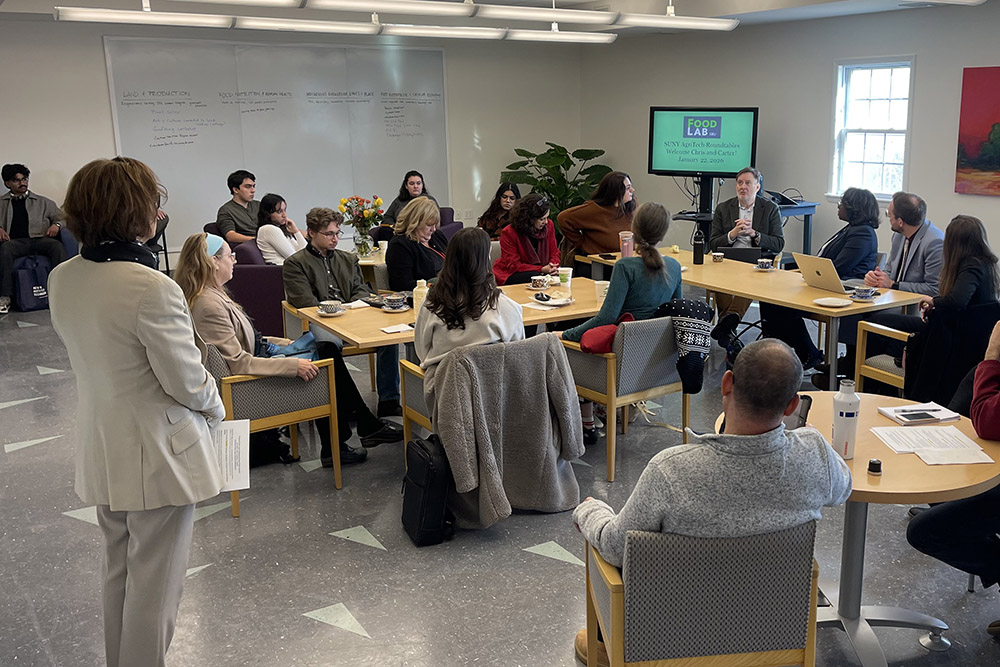 Students and faculty seated at a table