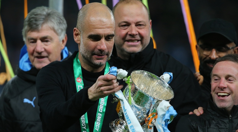 Pep Guardiola holding the Carabao Cup