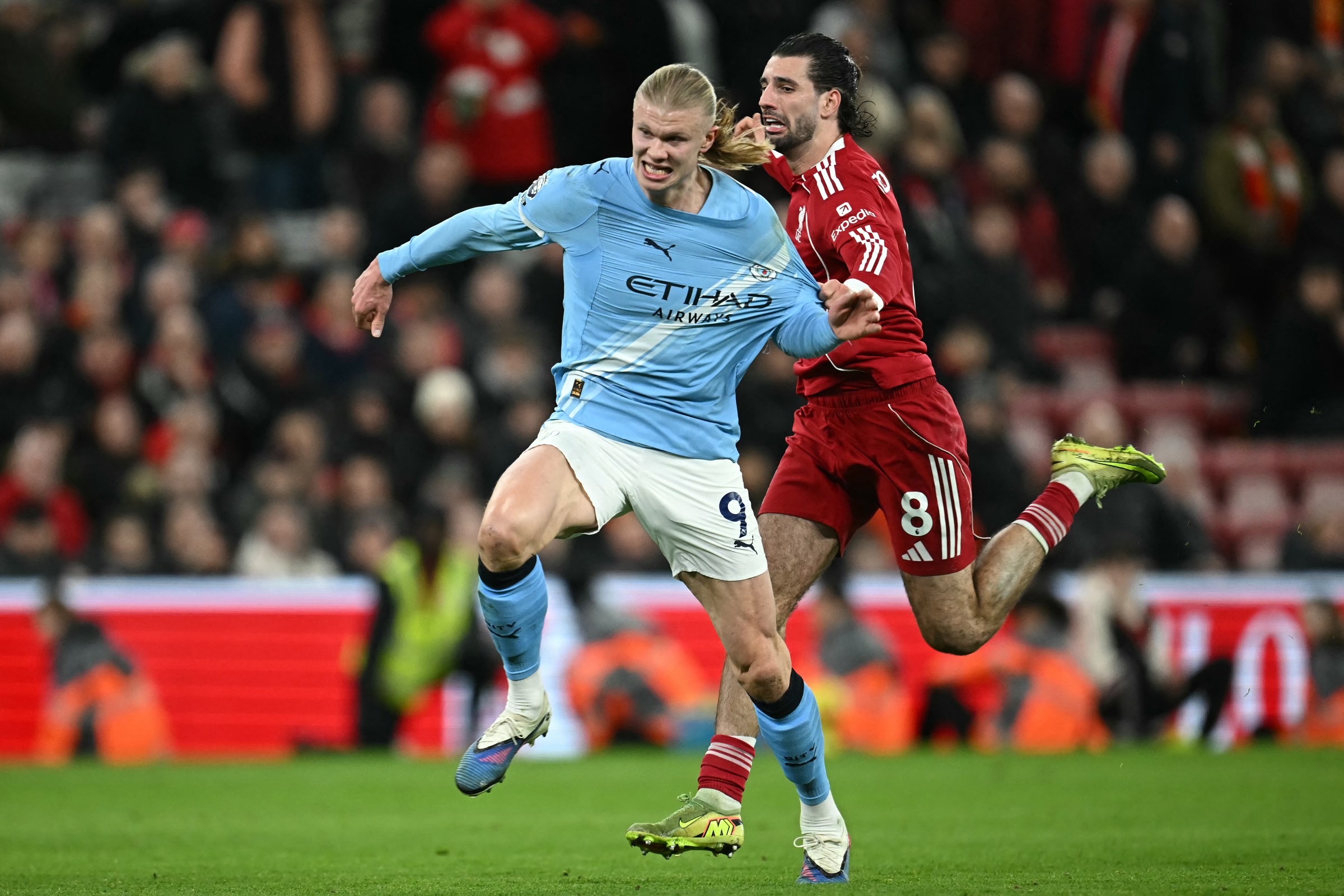 Liverpool’s Hungarian midfielder #08 Dominik Szoboszlai (R) fouls Manchester City’s Norwegian striker #09 Erling Haaland (L) which resulted in a red card at the end of the English Premier League football match between Liverpool and Manchester City at Anfield in Liverpool, north west England on February 8, 2026. (Photo by Paul ELLIS / AFP via Getty Images) / RESTRICTED TO EDITORIAL USE. No use with unauthorized audio, video, data, fixture lists, club/league logos or ‘live’ services. Online in-match use limited to 120 images. An additional 40 images may be used in extra time. No video emulation. Social media in-match use limited to 120 images. An additional 40 images may be used in extra time. No use in betting publications, games or single club/league/player publications. /