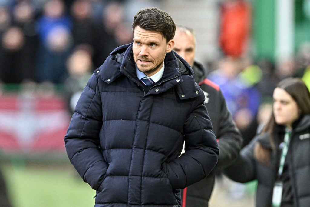 Rangers manager Danny Rohl stands on the touchline with his hands in his pockets.