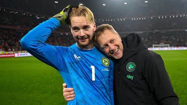 Republic of Ireland head coach Heimir Hallgrimsson and Republic of Ireland goalkeeper Caoimhin Kelleher celebrate after the FIFA World Cup 2026 Group F Qualifier match between Hungary and Republic of Ireland at Puskás Aréna in Budapest, Hungary.