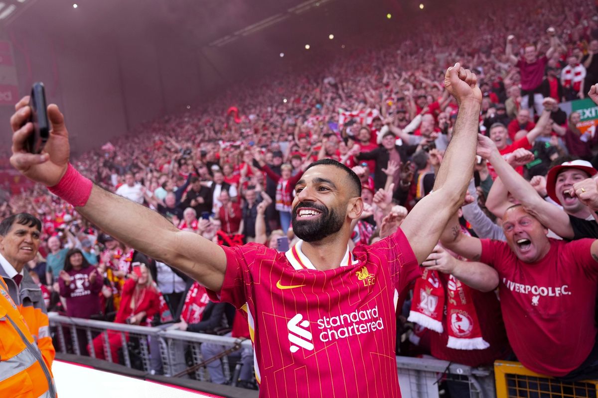 Liverpool's Mohamed Salah celebrates by taking a selfie after clinching the Premier League title at Anfield, Sunday, April 27, 2025