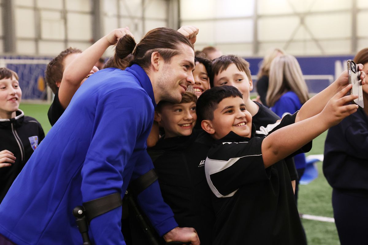 Jack Grealish poses for a selfie with participants of an Everton in the Community showcase at Finch Farm. Image: Tony McArdle/Everton FC