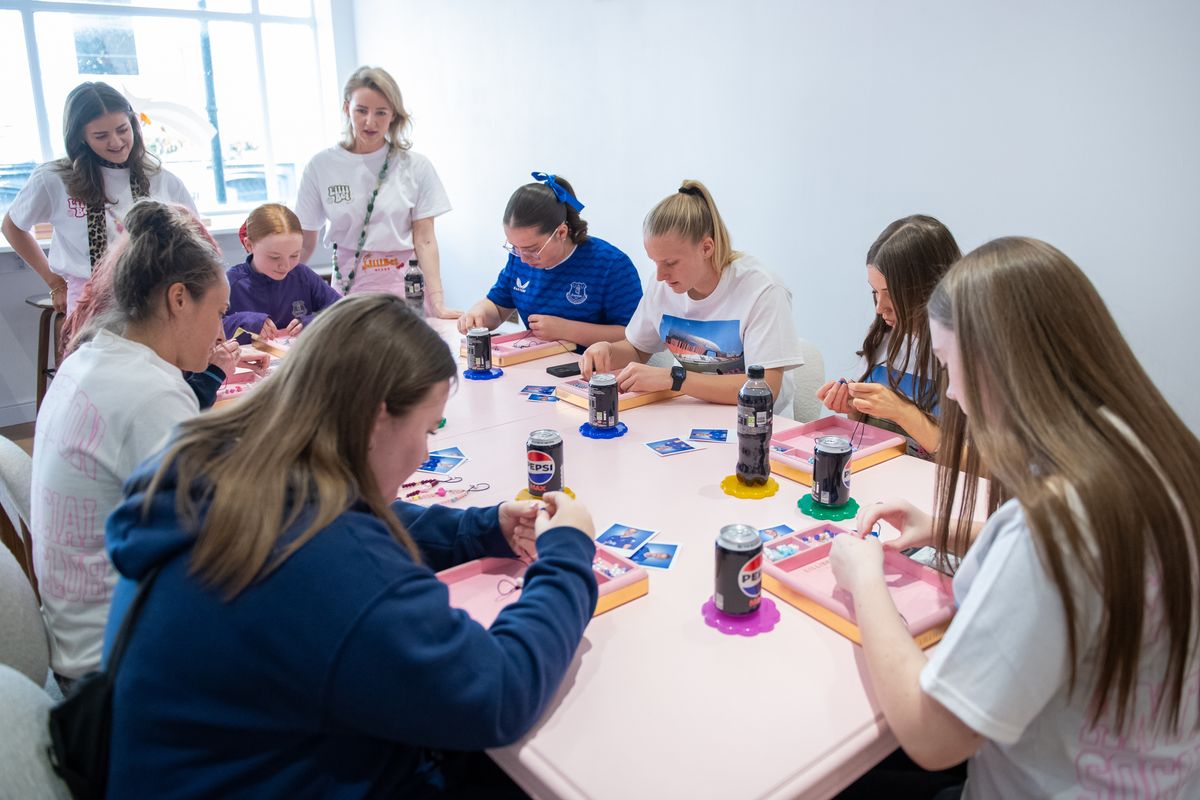 Zara Kramzar and Aurora Galli get stuck into the activities at a bracelet/bag-charm making workshop at LilliBet Beads on Lark Lane with a group of teenage Everton Women season ticket holders